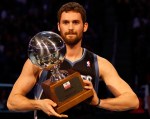 Ex-Bruin Kevin Love, now of the Minnesota Timberwolves, hoists the 3-point shooting title trophy at All-Star Weekend in Orlando. courtesy: Getty Images