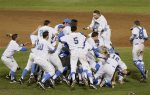 Bruins rush the mound celebrating UCLA's first baseball title, the school's 109th national championship. courtesy:   NATI HARNIK — AP Photo 